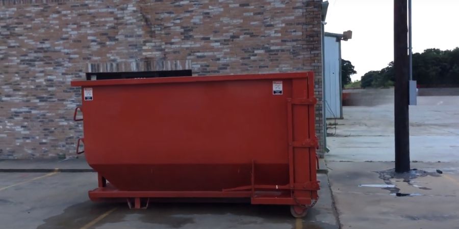 a red 15 cubic yard roll off dumpster in des moines, iowa